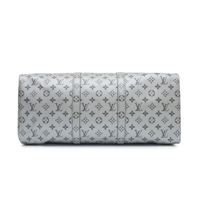 Louis Vuitton Metallic Monogram Keepall Bandoulière 50 in silver Monogram canvas with rolled top handles, silver-tone hardware, top zip closure and matching luggage tag.