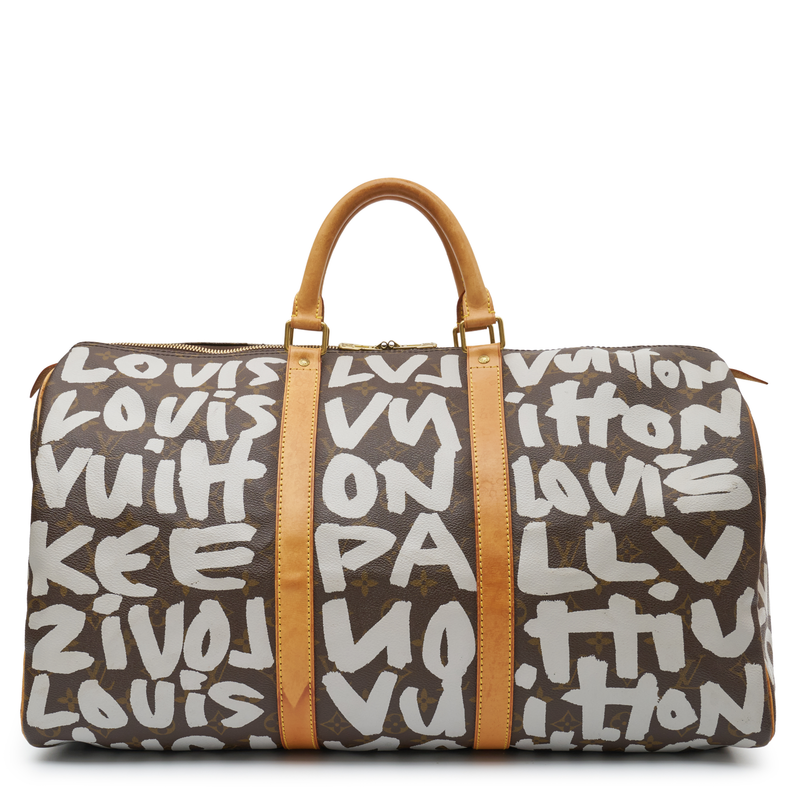 Louis Vuitton x Stephen Sprouse Graffiti Keepall 50 in brown Monogram canvas with oversized white graffiti lettering, Vachetta leather handles and gold-tone hardware.