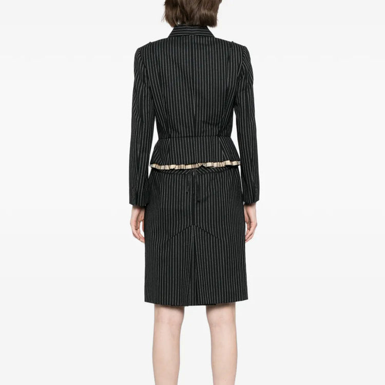 Louis Vuitton striped skirt suit set with blazer and matching skirt, shown from the back on a model.
