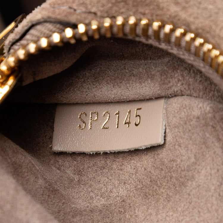Louis Vuitton Veau Cachemire Tote PM handbag in soft, beige leather with gold-tone hardware and spacious interior.