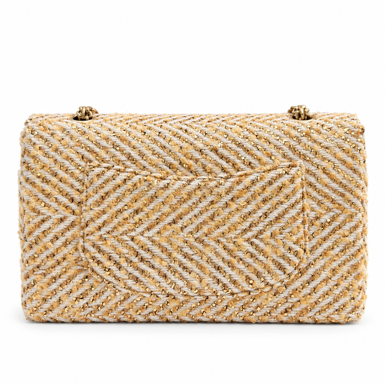 Chanel medium gold tweed shoulder bag with a single flap and chain strap, showcasing elegant texture and classic design.
