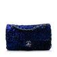 Chanel medium sequin shoulder bag with single flap and chain strap, sparkling sequins on black fabric for elegant style.