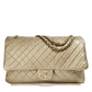 Metallic gold Chanel XXL airline travel flap bag with shoulder strap, featuring a sleek, shiny finish and spacious design.
