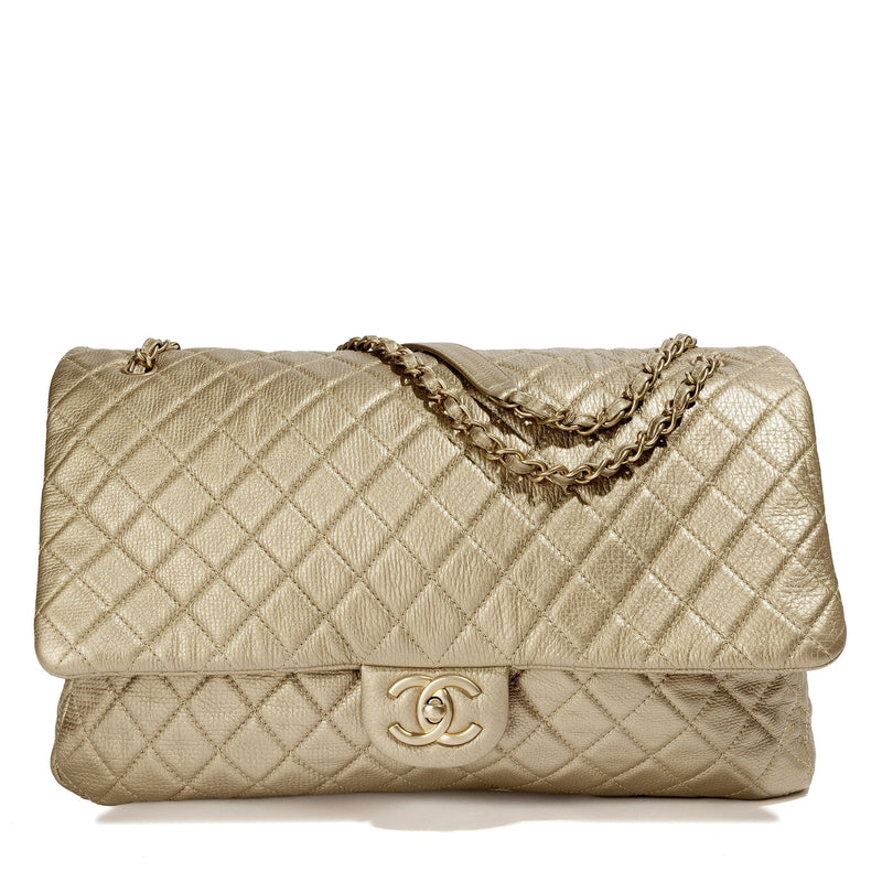 Metallic gold Chanel XXL airline travel flap bag with shoulder strap, featuring a sleek, shiny finish and spacious design.