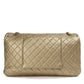 Metallic gold Chanel XXL airline travel flap bag with shoulder strap, featuring sleek design and luxurious finish.