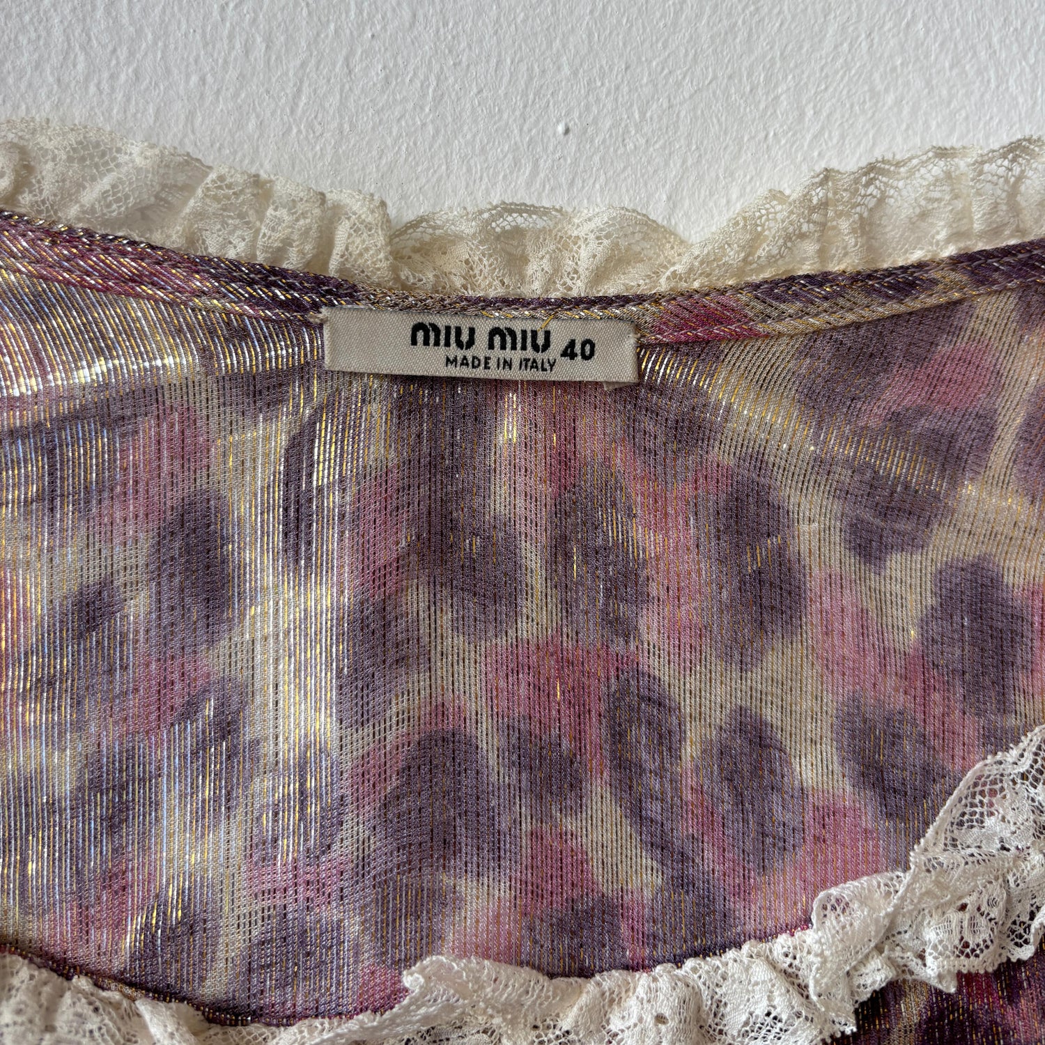 Miu Miu leopard print dress featuring a stylish, fitted silhouette with bold animal pattern and elegant design details.