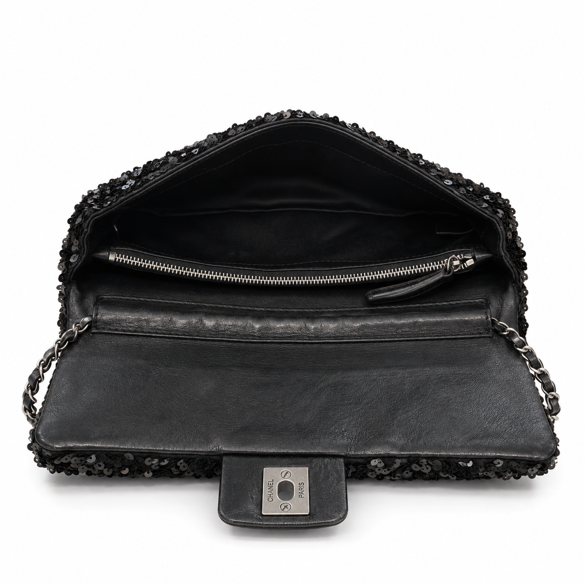 Open Chanel sequin east-west flap shoulder bag showing black interior lining and sleek design.