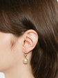 Pair of Chanel gold-tone hoop drop earrings featuring round cream faux pearls embellished with a small gold CC logo accent.
