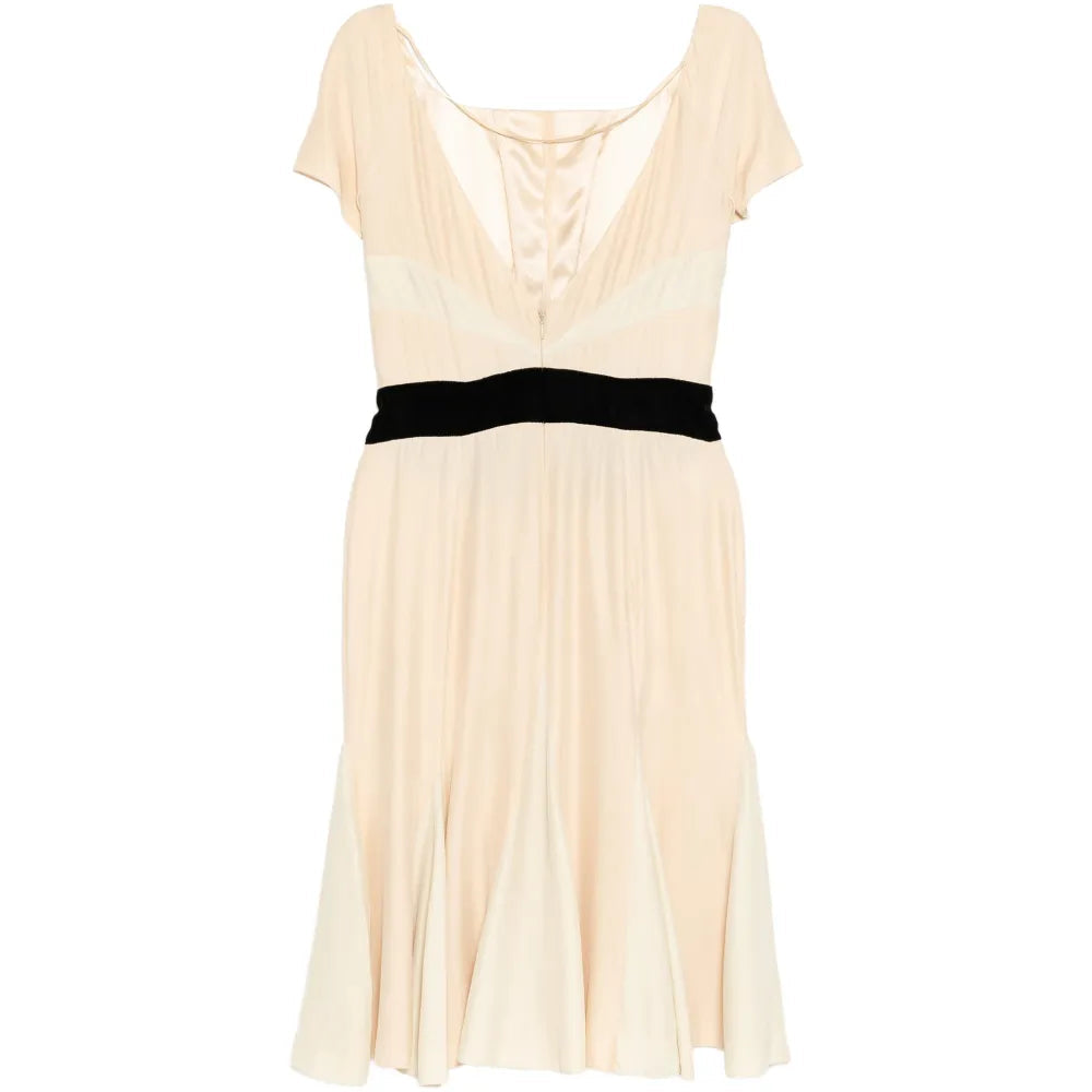 Elegant Prada pleated silk dress with flowing fabric and detailed pleats, shown from a side view.