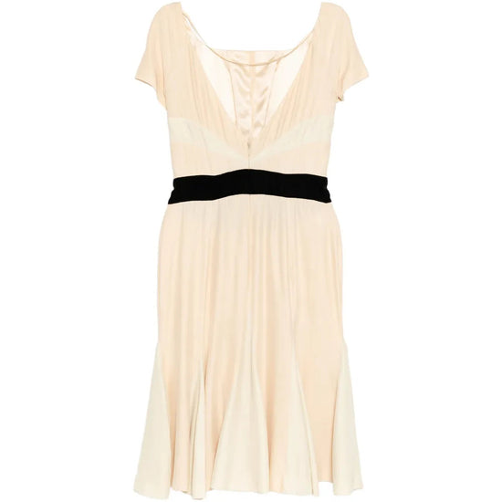 Elegant Prada pleated silk dress with flowing fabric and detailed pleats, shown from a side view.
