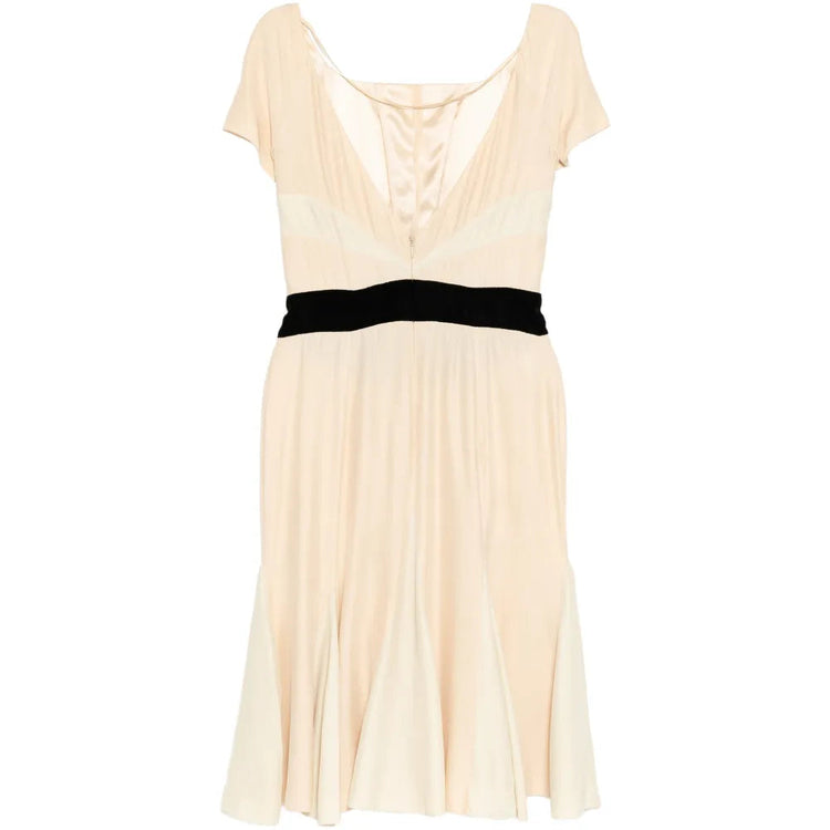 Elegant Prada pleated silk dress with flowing fabric and detailed pleats, shown from a side view.
