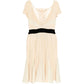 Elegant Prada pleated silk dress with flowing fabric and detailed pleats, shown from a side view.