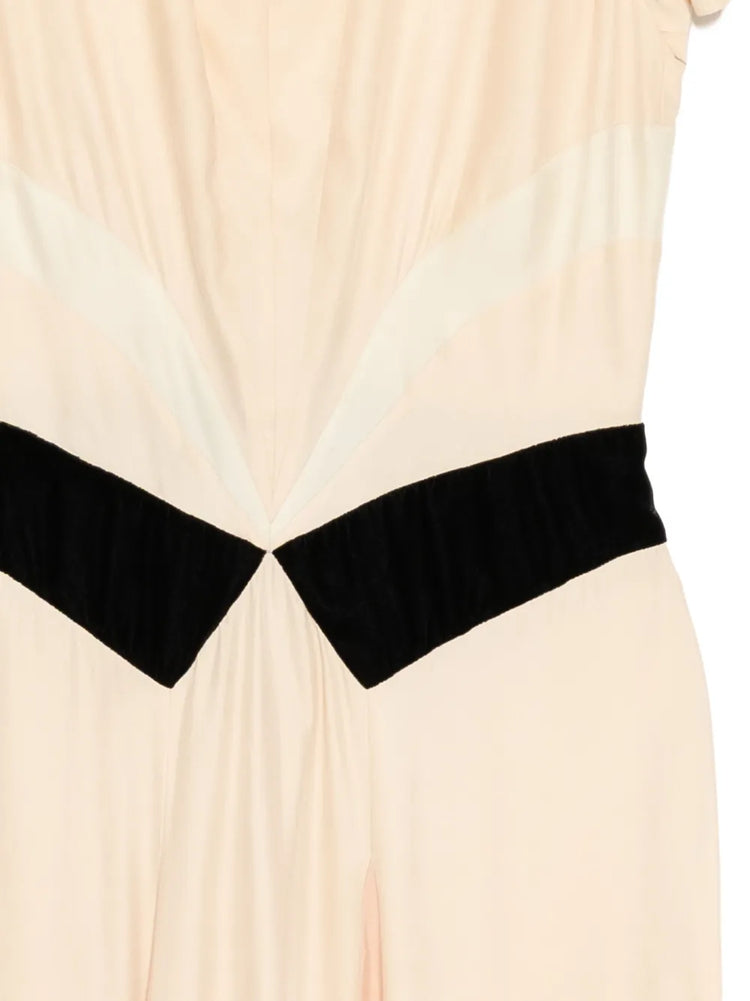 Prada pleated silk dress displayed from a side view, showcasing elegant pleats and smooth fabric in a stylish dress image.