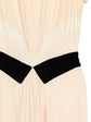 Prada pleated silk dress displayed from a side view, showcasing elegant pleats and smooth fabric in a stylish dress image.