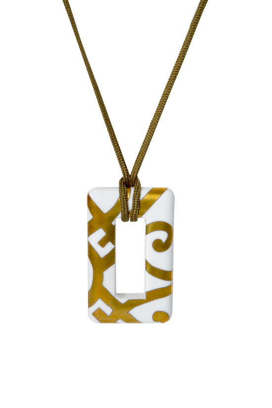 Hermès porcelain pendant necklace featuring a smooth, white ceramic pendant on a delicate chain, elegant jewelry accessory.