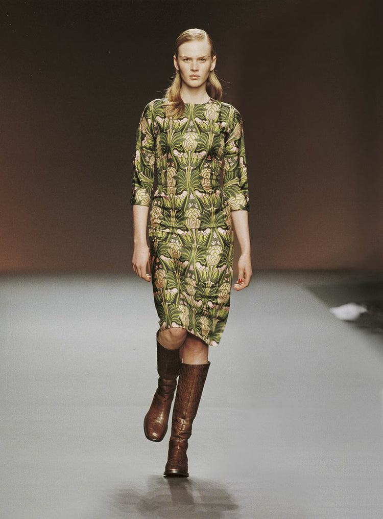 Prada fall 2003 pink and green floral dress with long sleeves and a fitted waist, displayed on a hanger.