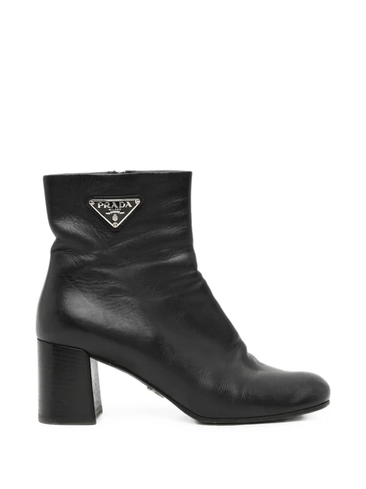 Black Prada ankle boots, stylish shoes with sleek design and pointed toe, made from smooth leather.