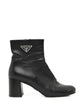Black Prada ankle boots, stylish shoes with sleek design and pointed toe, made from smooth leather.