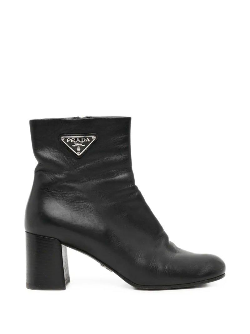Black Prada ankle boots, stylish shoes with sleek design and pointed toe, made from smooth leather.