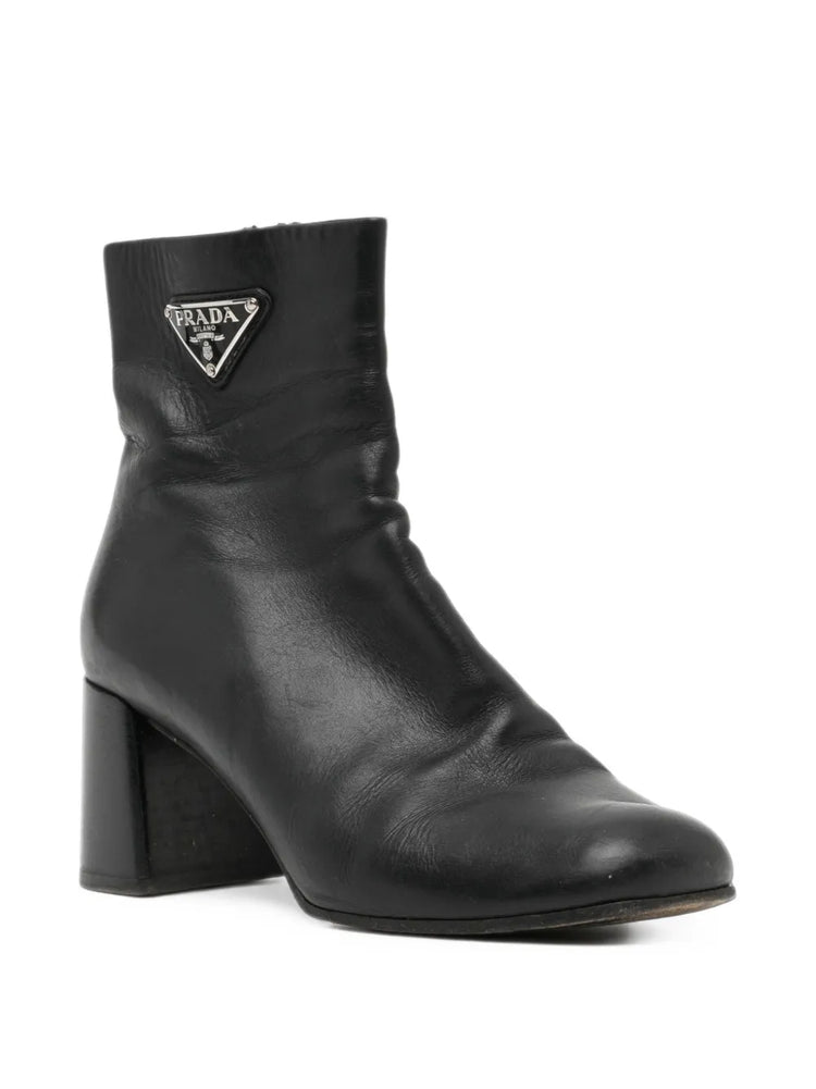Black Prada ankle boots with sleek leather design and side zipper, featuring a stylish low heel and pointed toe.