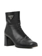 Black Prada ankle boots with sleek leather design and side zipper, featuring a stylish low heel and pointed toe.