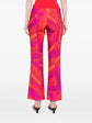 Pre-owned PUCCI printed cady straight-leg trousers displayed on a hanger with a vibrant pattern and clean tailoring.