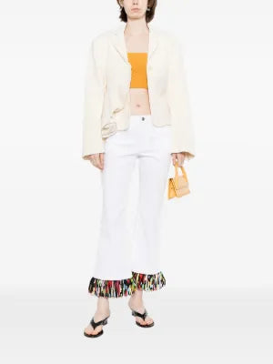 White fringed straight leg jeans by Emilio Pucci, featuring a classic fit with stylish fringe details on the trousers.