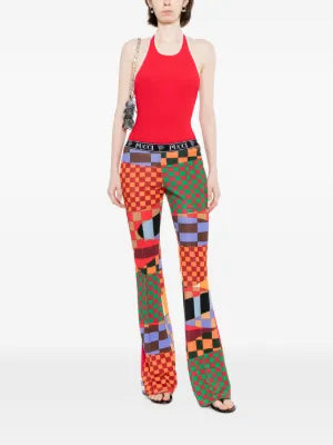Emilio Pucci printed jersey flared trousers displayed on a model, showcasing vibrant patterns and relaxed fit.