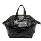 Black Saint Laurent Downtown patent leather tote handbag with sleek design and top handles, featuring a spacious interior.