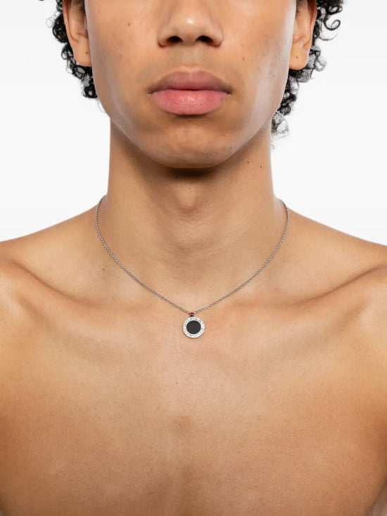 Bvlgari sterling silver Save the Children 10th Anniversary pendant necklace featuring a black onyx disc, a red ruby bail accent, and a Save the Children charm.