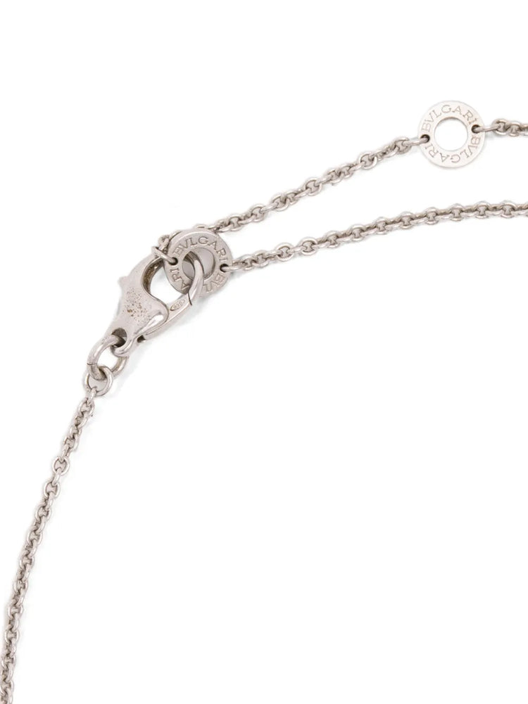 Bvlgari sterling silver Save the Children 10th Anniversary pendant necklace featuring a black onyx disc, a red ruby bail accent, and a Save the Children charm.