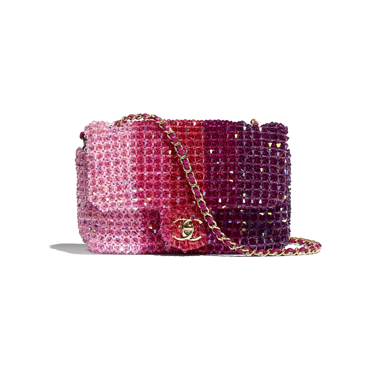 A Chanel shoulder bag  Spring/Summer 2020 Crystal Ombre Mini Flap covered in pink and purple rhinestones with a gold-tone chain strap and interlocking CC logo, shown on a white background.