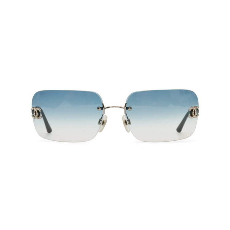 Rimless square sunglasses with a blue-to-white gradient lens and silver-tone metal hardware, shown against a plain white background.