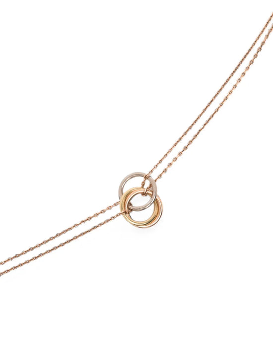 Cartier 18K tricolor yellow, white, and rose gold Trinity mini pendant necklace suspended on a double chain with a lobster clasp.