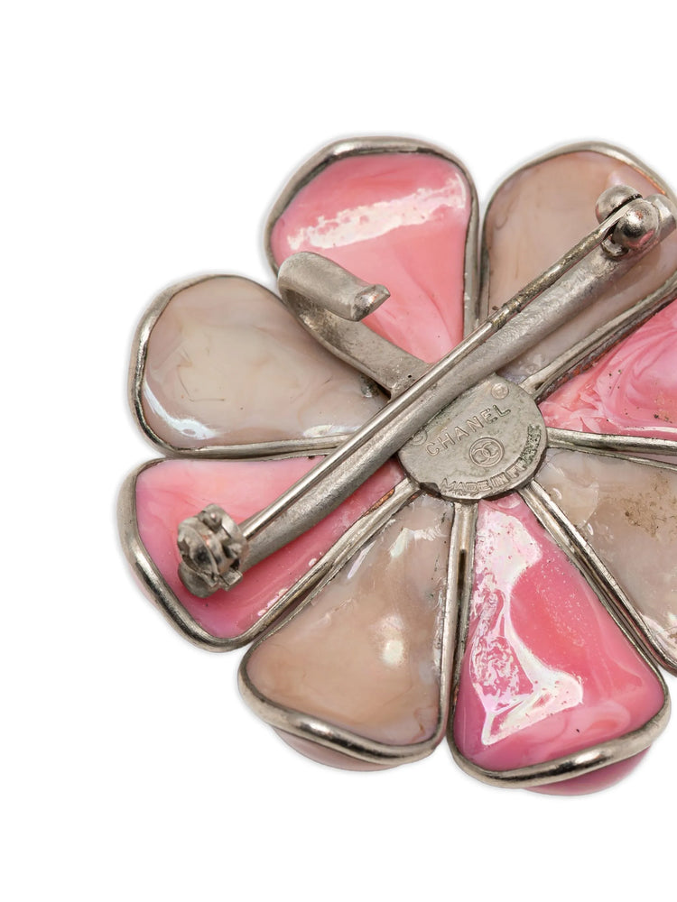 Vintage Chanel Camellia brooch with detailed floral design, gold-tone metal, and elegant craftsmanship.