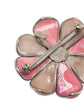 Vintage Chanel Camellia brooch with detailed floral design, gold-tone metal, and elegant craftsmanship.