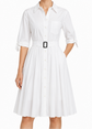 White Prada pleated shirt dress with long sleeves and a classic collar, styled with a flowing, elegant silhouette.