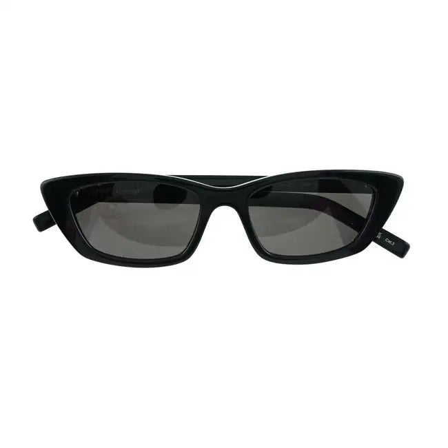 Black cat-eye sunglasses by Saint Laurent with dark tinted lenses and sleek black frames.