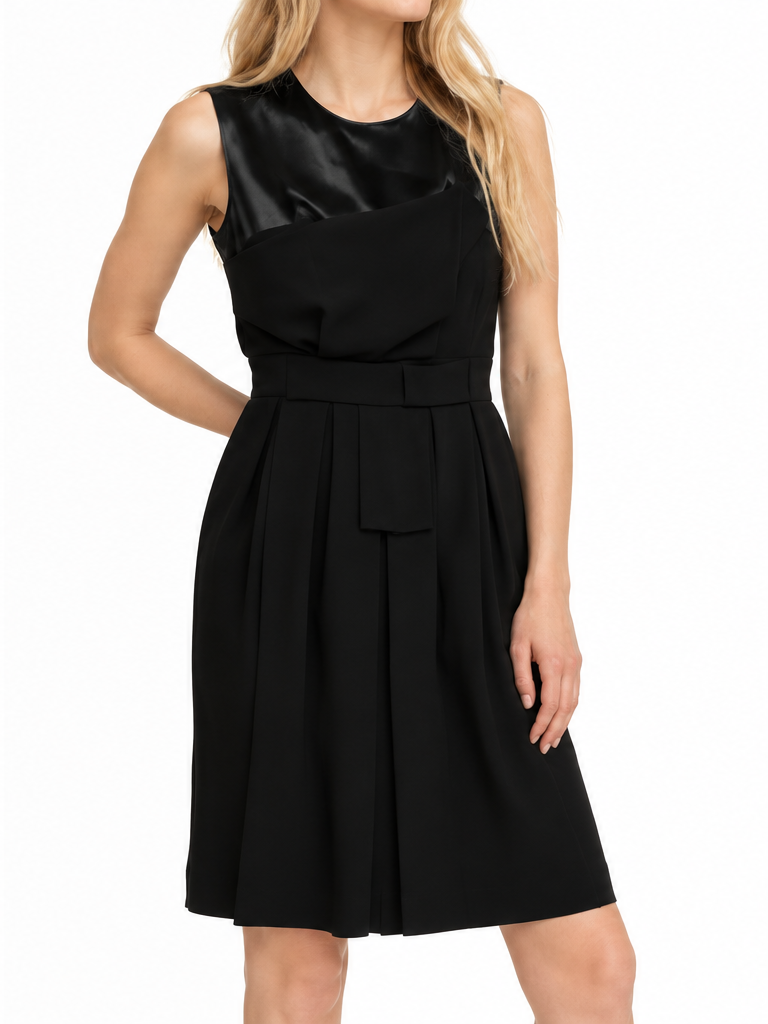 Black Dior tulle panel ribbon waist dress modeled on blonde woman against white background.