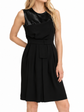 Black Dior tulle panel ribbon waist dress modeled on blonde woman against white background.