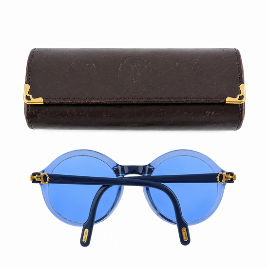 Cartier prescription sunglasses with blue frames and dark tinted lenses, stylish and protective eyewear for everyday wear.
