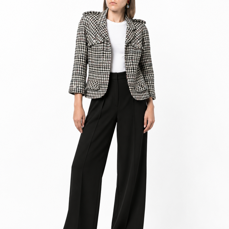 Chanel 2006 houndstooth zip-up jacket featuring classic pattern and tailored fit, displayed on a hanger.