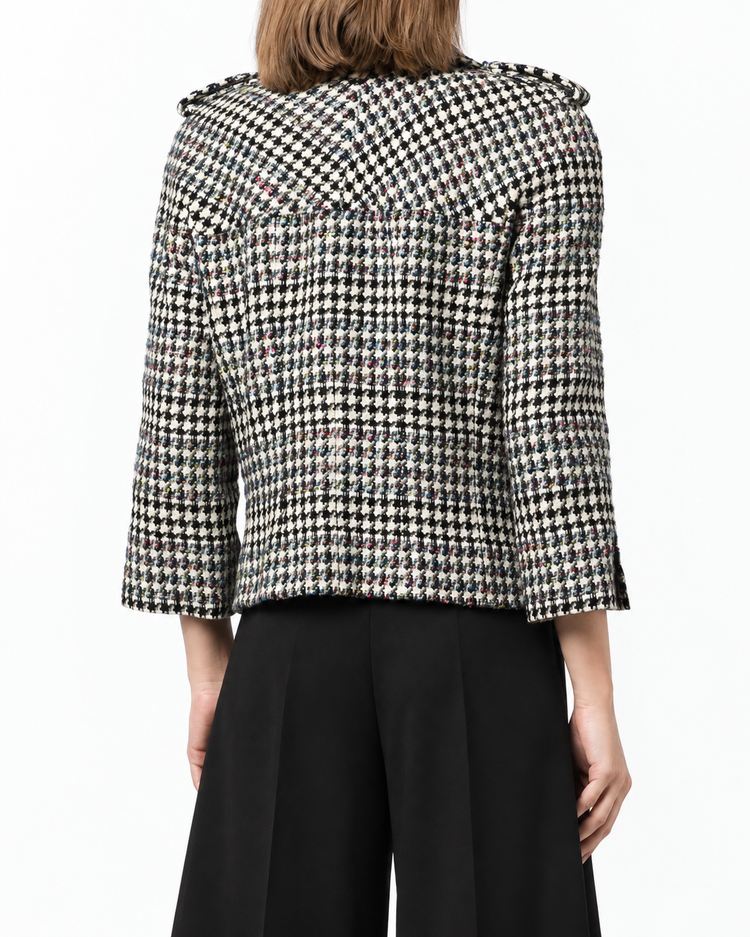 Chanel 2006 houndstooth zip-up jacket, blazer style with classic black and white pattern, shown on a mannequin.