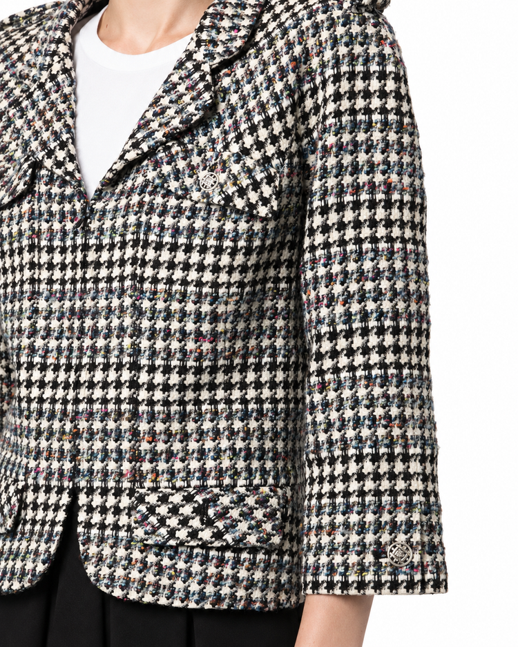 Chanel 2006 houndstooth zip-up jacket featuring a classic pattern, tailored fit, and stylish collar detail.