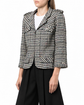 Chanel 2006 houndstooth zip-up jacket featuring a classic pattern, tailored fit, and stylish collar, displayed on a hanger.