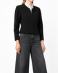 Chanel black cropped zip-up jacket with long sleeves, round neckline, central zip fastening and fitted panelled silhouette.