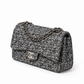 Silver tweed Chanel shoulder bag with sequins and a double flap design, featuring a stylish and elegant look.