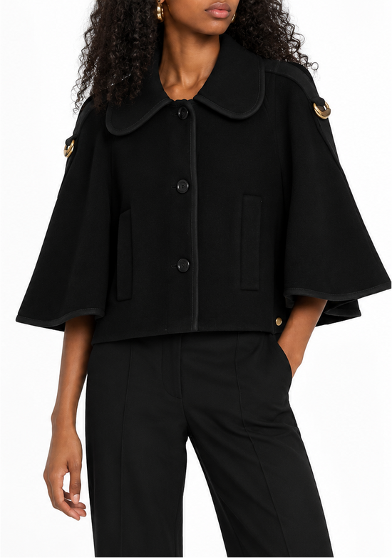 Chloé black cape-collar coat displayed on a model with a white background, showcasing the elegant outerwear design and fabric details.