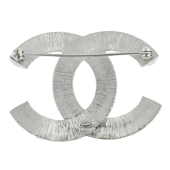 Elegant crystal Chanel pin brooch with intricate design, perfect for adding a touch of luxury to outfits.