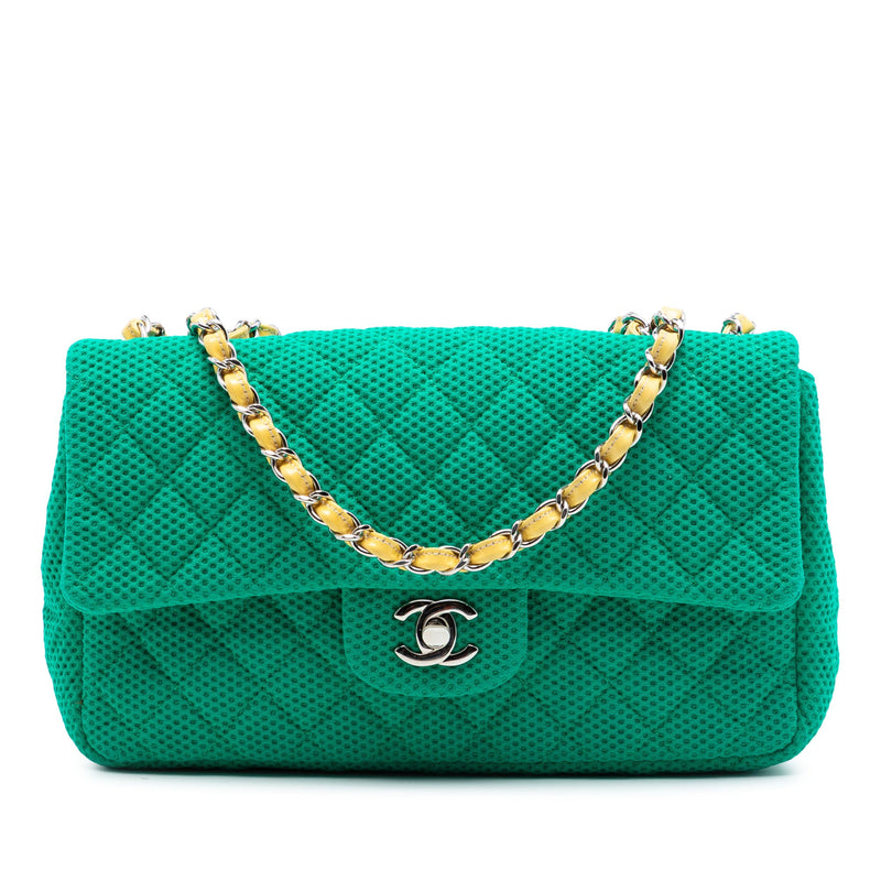 Chanel perforated calfskin expandable shoulder handbag with top handles and sleek design for stylish everyday use.